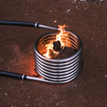 Wood fire coil kit burning beside a stock tank hot tub